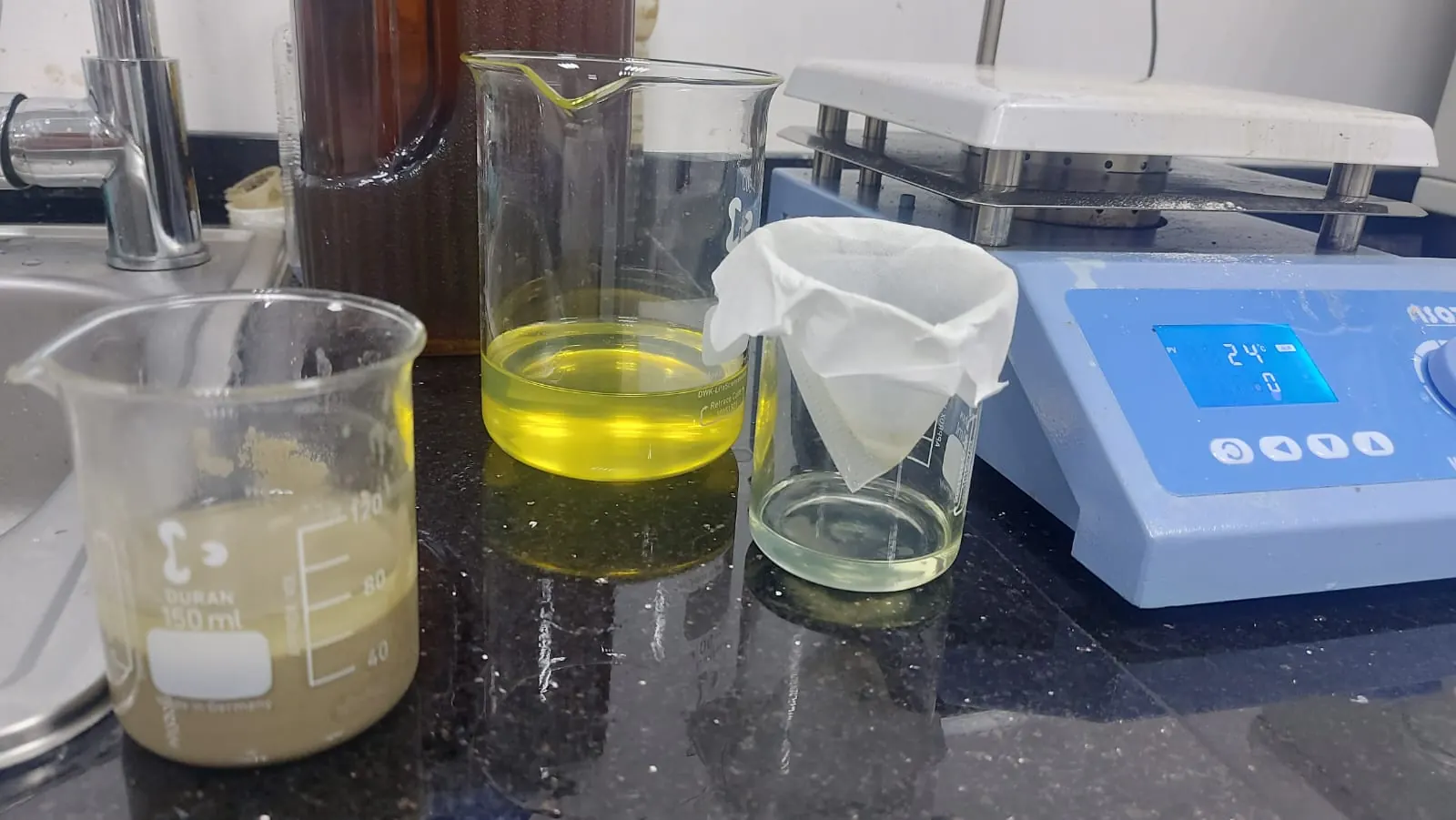Filtering a treated sample on APCO's laboratory bench beside the magnetic stirrer